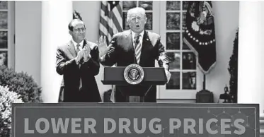  ?? OLIVIER DOULIERY/ABACA PRESS ?? President Donald Trump’s drug rebate plan was crafted by Health and Human Services Secretary Alex Azar, left.