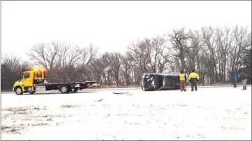  ??  ?? A rolled over vehicle sits on the side of the highway being prepared to be towed, during a post-Christmas blizzard in this photo provided by the Nebraska State Patrol, in Grand Island, Nebraska. — Reuters photo