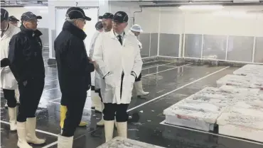  ??  ?? 0 Michael Gove talks to fishermen on a tour of Peterhead Fishmarket