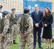  ?? REUTERS ?? Respect: The Duke and Duchess of Cambridge wear black in memory of Prince Philip as they chat to air cadets in London