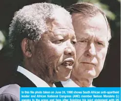  ??  ?? In this file photo taken on June 24, 1990 shows South African anti-apartheid leader and African National Congress (ANC) member Nelson Mandela (L) speaks to the press and fans after finishing his joint statement with US President George HW Bush (R) on the White House South Lawn.