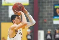  ??  ?? Adam Thistlewoo­d, a 6-foot-7 senior who is Golden’s leading scorer and has signed to attend Drake, says despite the turmoil, “if anything, we’re closer now.”