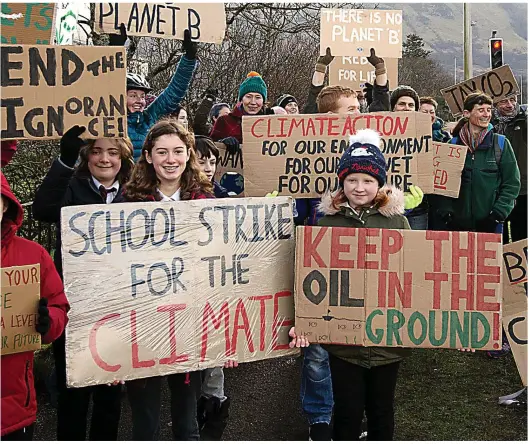  ??  ?? school friends outside Lochaber High School in Fort William. She has gone on strike every Friday for the past six weeks