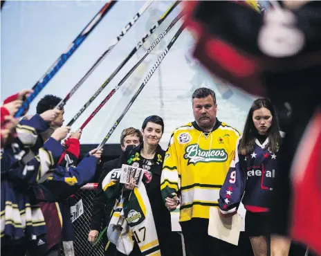  ?? KAYLE NEIS /THE CANADIAN PRESS ?? Scott Thomas, centre, walks with his family through the honour guard during the funeral of his son, Humboldt Broncos player Evan Thomas. The family has written a public letter of gratitude for the incredible support the community has show since Evan’s death.