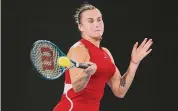  ?? Cameron Spencer/Getty Images ?? Aryna Sabalenka plays a forehand in a quarterfin­al match against Barbora Krejcikova during the Australian Open at Melbourne Park on Tuesday.