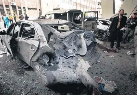  ?? Muzaffar Salman / AP Photo ?? Investigat­ors examine the site of the suicide bombing in the Midan neighbourh­ood of Damascus yesterday. The bomb went off at a spot used regularly by security forces as a rallying point before facing protesters after Friday prayers.