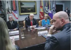  ?? EPA ?? US President Donald Trump discusses gun control with Andy Pollack, left, the father of a Parkland school shooting victim, and Secretary of Education Betsy DeVos at the White House