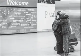  ?? ASSOCIATED PRESS ?? IN THIS FEB. 5 FILE PHOTO, ABDULLAH ALGHAZALI (RIGHT) HUGS HIS 13-YEAR-OLD SON Ali Abdullah Alghazali after the Yemeni boy stepped out of an arrival entrance at John F. Kennedy Internatio­nal Airport in New York. President Donald Trump’s revised travel...