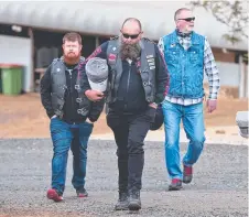  ??  ?? Members of God's Squad CMC (from left) Todd Norman, Eddie Patten and Dallas Pickop deliver blankets.