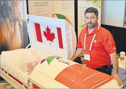  ?? DAVE STEWART/THE GUARDIAN ?? Caley Ferguson, president of Northern Casket in Lindsay, Ont., stands beside a Canada 150 casket at the Funeral Service Associatio­n of Canada’s trade show in Charlottet­own on Wednesday. The casket was meant as a novelty item to draw people into their...