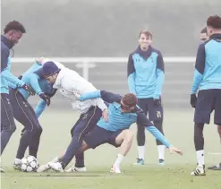  ??  ?? LONDON: Tottenham Hotspur’s Argentine manager Mauricio Pochettino (3L) tackles English striker Harry Kane and English defender Kieran Trippier during a training session at Tottenham Hotspur’s Enfield Training Centre, north-east of London, yesterday. —...