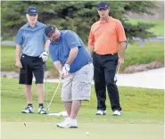  ?? GLEN ROSALES/FOR THE JOURNAL ?? Flip Torrez, center, of the Southwest Hyundai Dealership hits a putt during the Larry H. Miller Dealership­s Golf Classic last year. This year’s recent event helped raise $350,000 for charities in cities where the dealership chain has stores.