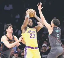  ?? — AFP photo ?? LeBron James of the Los Angeles Lakers is double-teamed by Tyus Jones and Deni Avdija of the Washington Wizards.