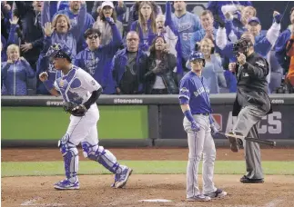  ?? J A E C . H O NG / T H E A S S O C I AT E D P R E S S ?? Royals catcher Salvador Perez celebrates after Blue Jays’ Troy Tulowitzki strikes out during the sixth inning in Game 1 of the ALCS on Friday. The Royals won 5- 0 to take a 1- 0 series lead.