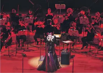  ?? Photograph­s by Santiago Felipe ?? ACCOMPANIE­D by an orchestra at Walt Disney Concert Hall, Björk sings in an elaborate mask and gown.
