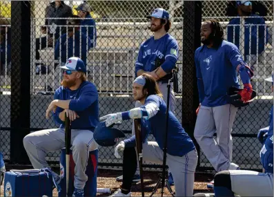  ?? CANADIAN PRESS PHOTO ?? Toronto Blue Jays players (left to right) Justin Turner, Bo Bichette, Jordan Romano and Vladimir Guerrero Jr. watch batting practice in Dunedin, Fla. on Thursday, Feb. 22, 2024. There was no roster makeover, blockbuste­r trade or eye-popping free-agent signing for the Blue Jays this past off-season. The club is essentiall­y running it back with virtually the same core as last year and hoping the bats return to form.