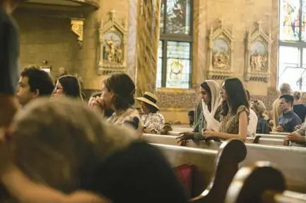  ?? VINCENT D. JOHNSON PHOTOS/FOR CHICAGO TRIBUNE ?? Elizabeth Chaidez and her sister Annette Chaidez, right, attend the Latin Mass at St. John Cantius Catholic Church in Chicago on Sept. 18. Both were in a group earlier that day learning about the Mass.