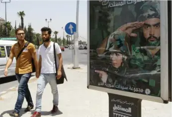 ?? LOUAI BESHARA/AFP/GETTY IMAGES ?? Damascus has seen a number of army recruitmen­t billboards since the Syrian army has become overstretc­hed.