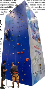  ??  ?? Holiday thrill The long weekend capped by the Muslim Eid al-Adha observance allowed active mall goers to spend their time wall climbing.