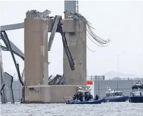  ?? Photo: Reuters ?? Emergency boats work near the collapsed section of the Francis Scott Key Bridge, after the Dali cargo vessel crashed into it, in Baltimore, Maryland, U.S., on March 27, 2024.