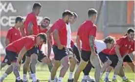  ??  ?? LISBON: Benfica’s Brazilian forward Gabriel Gonzaga (3L) chats with countryman midfielder Filipe Augusto (2L) during a training session the club’s training ground in Seixal, outskirts of Lisbon, yesterday, on the eve of the UEFA Champions League...