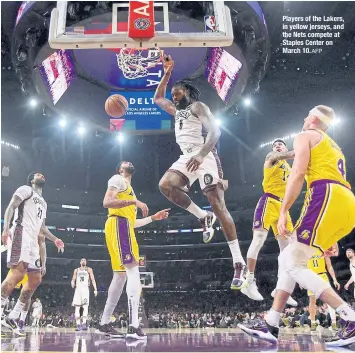  ?? AFP ?? Players of the Lakers, in yellow jerseys, and the Nets compete at Staples Center on March 10.