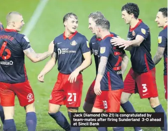  ??  ?? Jack Diamond (No 21) is congratula­ted by team-mates after firing Sunderland 3-0 ahead at Sincil Bank