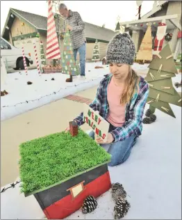  ?? Dan Watson/For the Signal ?? Bob Dodge and his granddaugh­ter Jenna Espinoza, 13, fine tune the display of unique hand made Christmas trees entitled the “Land of Misfit Trees” in Bob’s front yard.