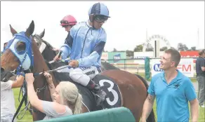  ??  ?? GOOD RUN: Jockey Trent Germaine and trainer James Dodgson show their satisfacti­on in Oostrerman winning the MIXX FM Santa Races Handicap. Picture: PAUL CARRACHER