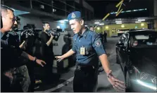  ?? Picture: AFP ?? BACK OFF: A Malaysian policeman blocks members of the media as a North Korean embassy official leaves Kuala Lumpur Hospital’s forensic department yesterday