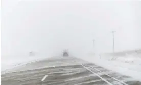  ?? Photograph: Carolyn Kaster/AP ?? Tractor-trailers travel on the snow-streaked lanes of US Highway 20 during a blizzard near Holstein, Iowa, on Saturday.