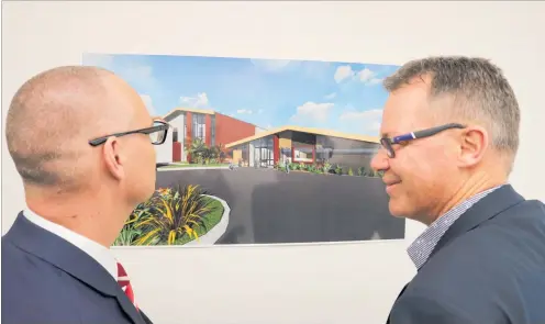  ?? PHOTO / PETER DE GRAAF ?? Health board chief executive Nick Chamberlai­n (right) shows Health Minister David Clark an artist’s impression of the primary care centre during the opening of phase one of the Bay of Islands Hospital rebuild.