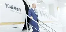  ?? PAUL CHIASSON/THE CANADIAN PRESS ?? Bombardier CEO Alain Bellemare steps off of a model of a Global 7000 jet before holding a press conference in Montreal earlier this month.