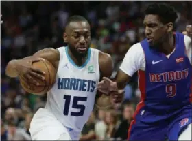  ?? DUANE BURLESON - THE ASSOCIATED PRESS ?? File-This April 7, 2019, file photo shows Charlotte Hornets guard Kemba Walker (15) driving against Detroit Pistons guard Langston Galloway (9) during the second half of an NBA basketball game in Detroit.