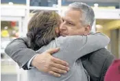  ?? TOM GRALISH/THE PHILADELPH­IA INQUIRER ?? Jim Demetros hugs his wife, Cindy, as she arrives to pick him up after his plane made an emergency landing.