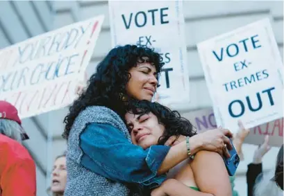  ?? JOSIE LEPE/AP ?? Mitzi Rivas, left, hugs her daughter Maya Iribarren during an abortion-rights protest at City Hall in San Francisco following the Supreme Court’s decision to overturn Roe v. Wade on June 24.