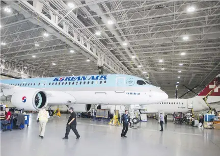  ?? RYAN REMIORZ/THE CANADIAN PRESS ?? Bombardier staff work on C Series CS300 jets at the company’s plant in Mirabel, Que. The Montreal-based firm accused the U.S. of “hypocrisy” for similarly selling aircraft below production costs, as it decided to add an 80-per-cent anti-dumping duty...