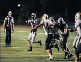  ?? Christian Monterrosa/The Signal ?? Saugus’ Nathan Eldridge (28) scrambles to make a pass in a 44-2 playoff win against Sonora High School at College of the Canyons on Friday.