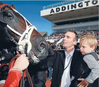  ?? Photo: JOSEPH JOHNSON/FAIRFAX NZ ?? Sweet success: Co-trainer Paul Court and son Taylor welcome back Terror To Love after last year’s New Zealand Trotting Cup victory.