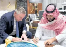  ?? GETTY IMAGES ?? Saudi Crown Prince Mohammed bin Salman, right, and Klaus Kleinfeld sign an agreement following the Crown Prince’s appointmen­t of Kleinfeld as Neom’s chief executive officer, in Riyadh, Saudi Arabia.