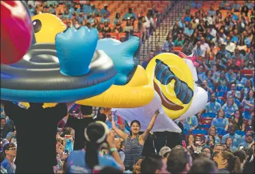  ?? NWA Democrat-Gazette/JASON IVESTER ?? Pool inflatable­s are paraded through the audience Wednesday during the Wal-Mart U.S. employees meeting at Bud Walton Arena in Fayettevil­le.