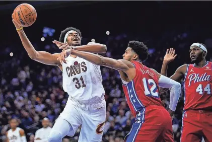  ?? MATT SLOCUM/AP ?? Cavaliers’ Jarrett Allen, left, is fouled by 76ers’ Tobias Harris during the first half on Friday in Philadelph­ia.