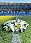  ??  ?? Show of support: Players console Vichai Srivaddhan­aprabha’s son, Aiyawatt (main) after a wreath was laid; he takes in the sea of tributes with Jamie Vardy and Kasper Schmeichel (top) and youth player Darnell Johnson lays a tribute (right)