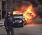  ?? SEAN DOUGHERTY/USA TODAY ?? Parked cars burn on K Street, the capital’s power corridor, after President Trump’s inaugurati­on on Jan. 20.