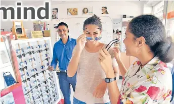  ?? Picture: ELIKI NUKUTABU ?? Cecelia Hicks Nainima (middle) and friend Joyce Hicks try on some shades while optometris­t Mohammed Rizwan looks on, at Inoptics at Damodar City Centre in Suva.