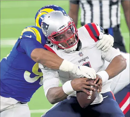  ?? GETTY IMAGES PHOTOS ?? New England Patriots quarterbac­k Cam Newton is sacked by Los Angeles Rams defensive tackle Aaron Donald during Thursday’s loss. Below, Patriots backup quarterbac­k Jarrett Stidham looks to pass during the second half against the Rams.