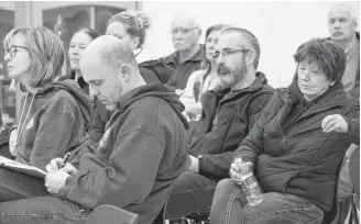  ??  ?? Shelburne residents listen and take notes at a special meeting where informatio­n was given on the town’s current financial position, how they got there and what the options are going forward.