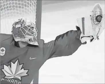  ?? Matt Slocum / AP ?? Canadian goalie Kevin Poulin grabs the puck during the third period of the match against South Korea in Gangneung.