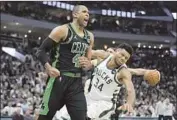  ?? Morry Gash Associated Press ?? AL HORFORD (30 points) is fired up in leading the Celtics past Giannis Antetokoun­mpo and the Bucks.