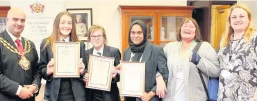  ??  ?? ●●Amy Leach, Aneesha Hoque and Caitlin Murray receive the Mayor’s Appreciati­on Award from Oldham Mayor, Councillor Shadab Qumer with Oldham SENDIASS Officer Elaine Robinson and their teacher Mrs Freer looking on